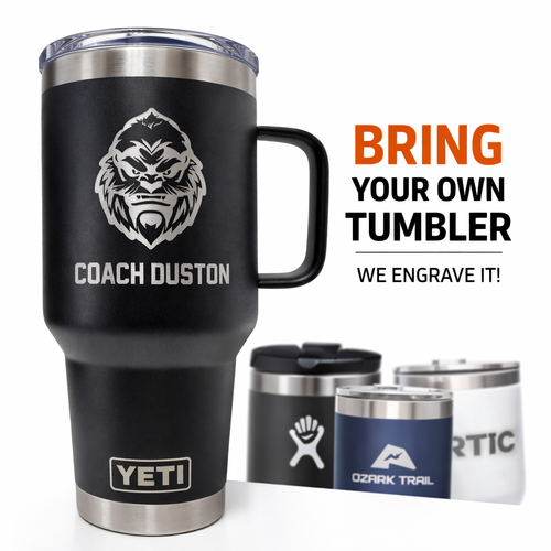 Black YETI tumbler with engraved design and text, surrounded by other branded tumblers.
