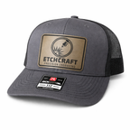 Gray trucker cap with Etchcraft logo on a white background