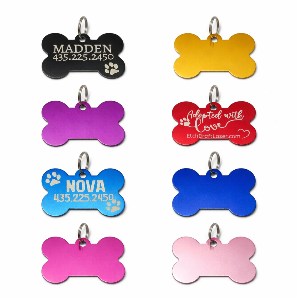 Collection of colorful pet ID tags with various designs on a white background