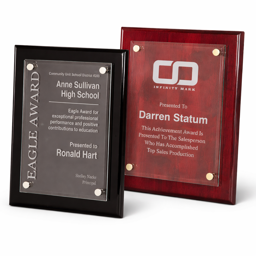 Two award plaques, one black and one red with a logo, on a white background.