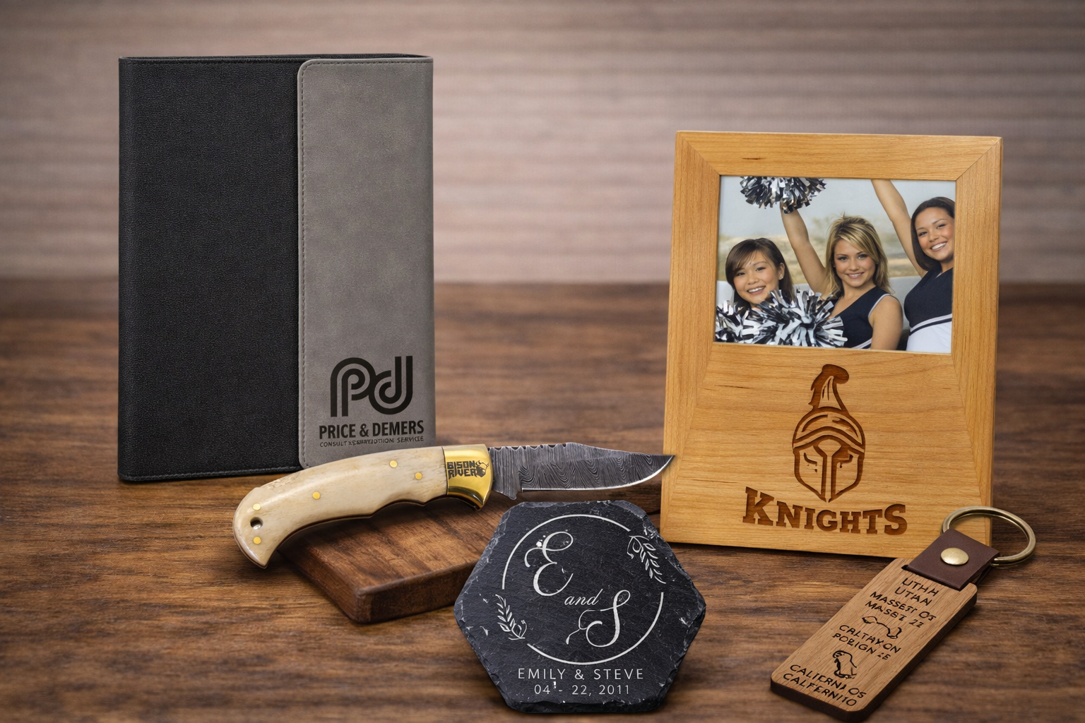 Collection of personalized items including a photo frame, knife handle, and engraved stones on a wooden surface.
