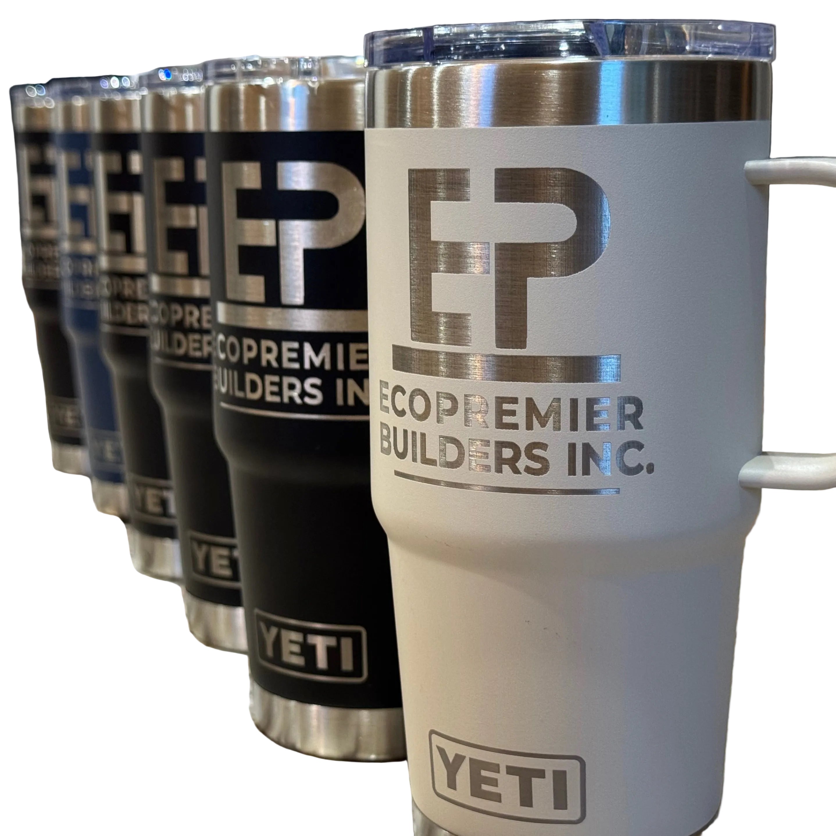 Row of Yeti tumblers with EcoPremier Builders Inc. branding on a marble surface.