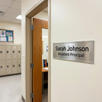 Office door with a nameplate reading 'Sarah Johnson Assistant Principal' in an indoor setting.