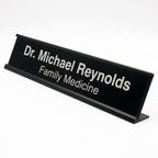 Black nameplate with 'Dr. Michael Reynolds Family Medicine' text on a white background