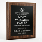 Wooden plaque with 'Most Valuable Player' award for Varsity Football on a white background