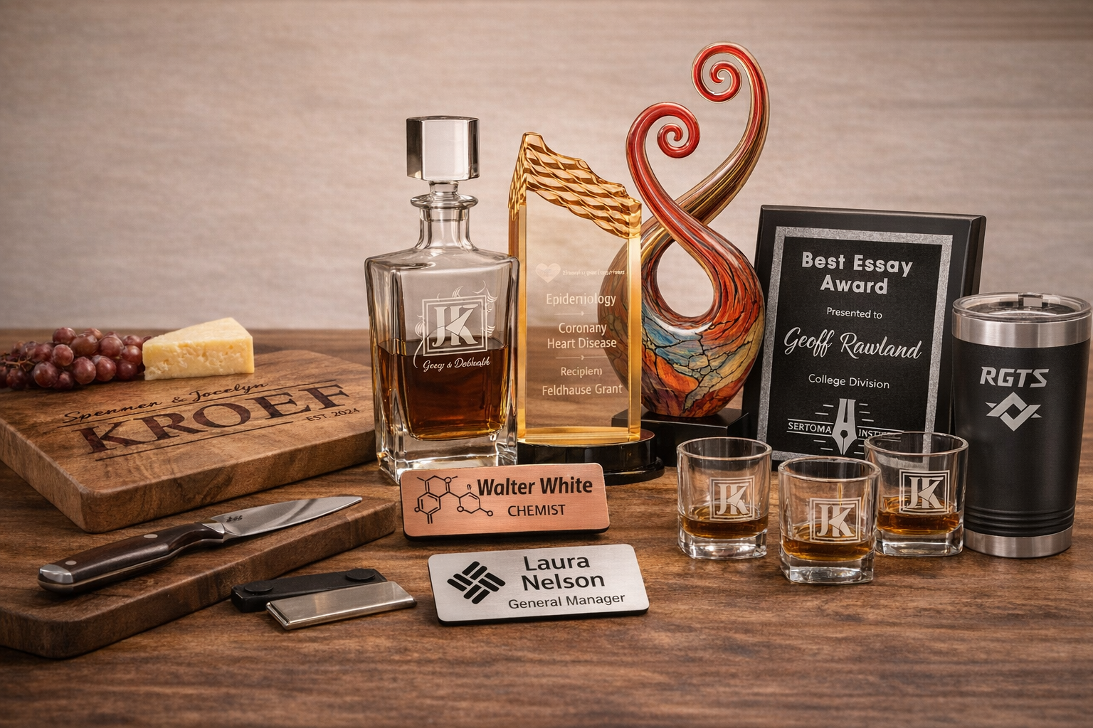 Collection of personalized items including a decanter, glasses, and awards on a wooden surface.